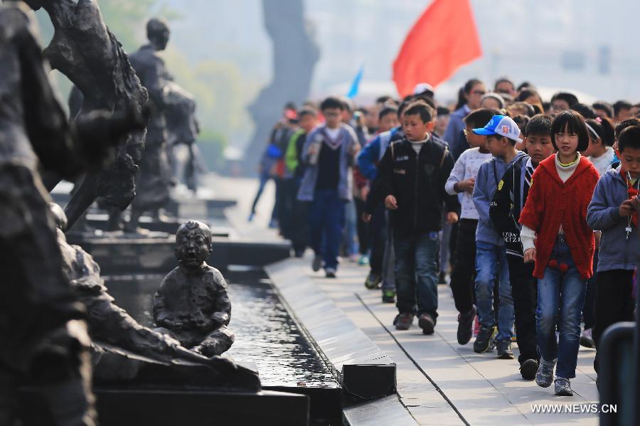 Students visit the Memorial Hall of the Victims in Nanjing Massacre by Japanese Invaders, in Nanjing, capital of east China's Jiansu Province, April 3, 2013. Lots of citizens came here to mourn Nanjing Massacre victims on the occassion of Qingming Festival, or Tomb-Sweeping Day, which falls on April 4 this year. (Xinhua/Han Hua)