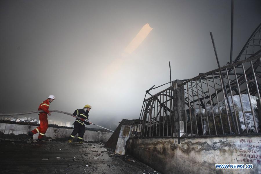Firemen put out a fire at the Zhangwan Farmers Market in Shiyan City, central China's Hubei Province, April 3, 2013. The fire broke out around 2:20 p.m. at the market and was put out later, leaving one person injured. (Xinhua) 