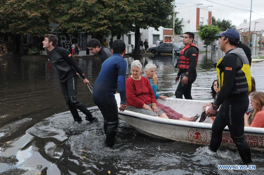 A young man stands on the roof of a house in a flooded area after a storm, in neighborhood Tolosa, La Plata, 63 km south of Buenos Aires, Argentina, on April 3, 2013. At least 46 people have died due to heavy storms in La Plata, and another 3,000 have been evacuated. (Xinhua/TELAM) 