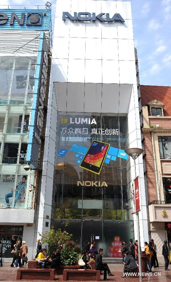 Pedestrians walk past Nokia's flagship store in Nanjing East Road in Shanghai, east China, April 3, 2013. The retail store, which is Nokia's only stand-alone flagship store and the largest around the world, was found closed in recent days. (Xinhua/Lai Xinlin)  