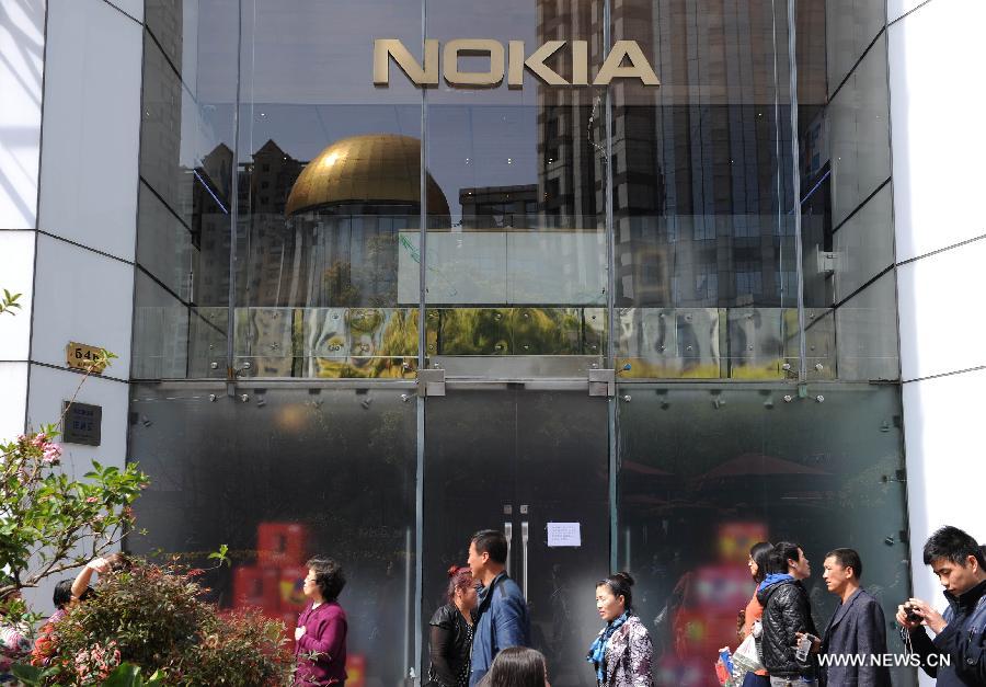 Pedestrians walk past Nokia's flagship store in Nanjing East Road in Shanghai, east China, April 3, 2013. The retail store, which is Nokia's only stand-alone flagship store and the largest around the world, was found closed in recent days. (Xinhua/Lai Xinlin)  