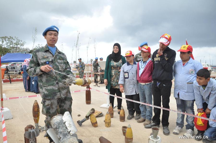 Chinese peacekeepers give a lesson to the local students about mine during an activity to mark the International Day of Mine Awareness and Assistance in Mine Action in Naqoura, southern Lebanon, April 4, 2013. The United Nations Interim Force in Lebanon (UNIFIL) observed Thursday the International Day of Mine Awareness and Assistance in Mine Action at its headquarters in Naqoura, southern Lebanon. (Xinhua/Liu Song) 