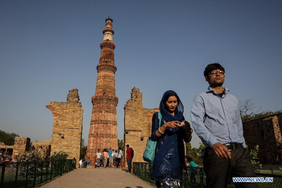 People visit the Qutab Minar in New Delhi, India, on April 5, 2013. Qutab Minar, a UNESCO World Heritage Site, is the tallest minaret in India. It is 75.56 metres high with a base a diameter of 14.3 metres, which narrows to 2.7 metres at the top storey. The minar is made of red sandstone and marble, and covered with intricate carvings. The construction of Qutab Minar started in 1193 by Qutub-ud-din Aibak and was completed by his inheritor Iltutmish. It is surrounded by several other ancient and medieval structures and ruins, collectively known as the Qutub complex, which attracts many visitors till now. (Xinhua/Zheng Huansong)