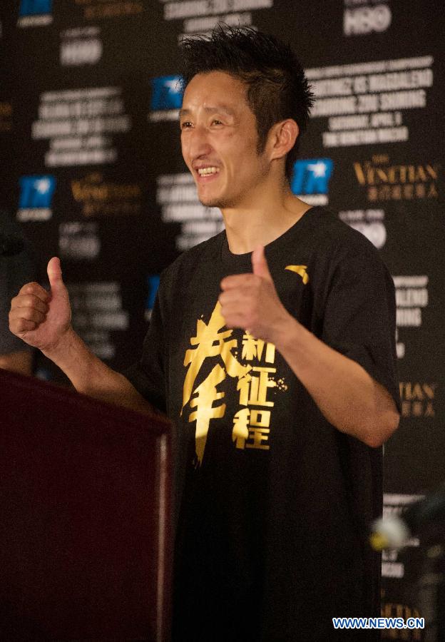 Two-time Olympic gold medalist China's Zou Shiming gestures during a press conference after his professional debut against Mexico's Eleazar Valenzuela in Macao, China, April 6, 2013. (Xinhua/Cheong Kam Ka)