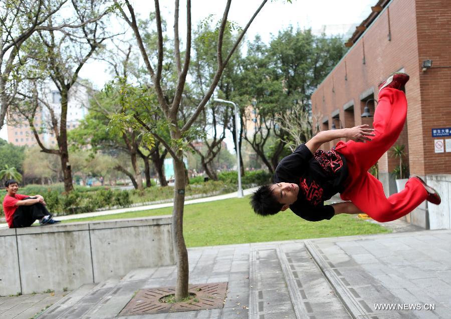 A young man practices parkour at the campus of Taiwan University in Taipei, southeast China's Taiwan, April 7, 2013. Parkour is an activity with the aim of moving from one point to another as efficiently and quickly as possible, using principally the abilities of the human body. (Xinhua/Xie Xiudong)