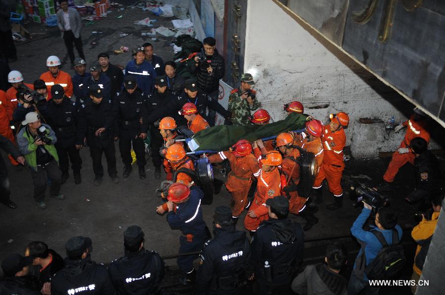 Rescued miner Liang Guanghua is carried out of the mine shaft of a flooded coal mine in Weng'an County, southwest China's Guizhou Province, April 8, 2013. Three miners trapped in the flooded Yunda Coal Mine for about 60 hours were rescued early Monday morning. Three others remained missing at the mine, which was hit by flood last Friday. Rescuers had earlier confirmed that three miners had been dead. (Xinhua/Liu Xu)