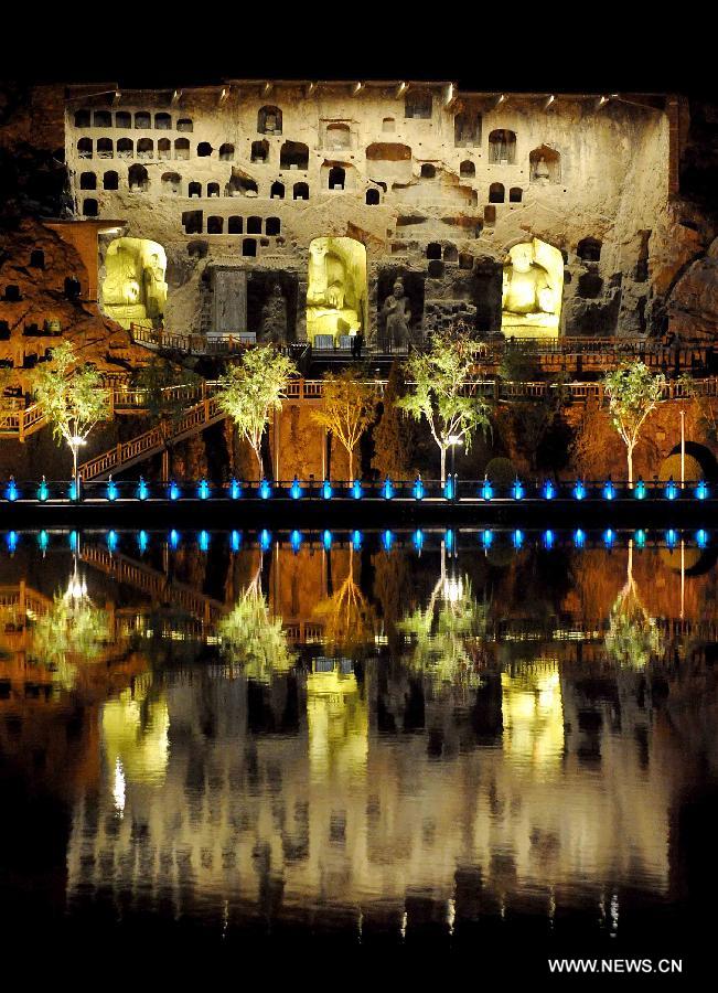 Photo taken on April 8, 2013 shows the night scenery of scenic area of Longmen Grottoes in Luoyang, central China's Henan Province. The night tour at Longmen Grottoes, a world cultural heritage site, has been opened to public since Monday. (Xinhua/Wang Song)