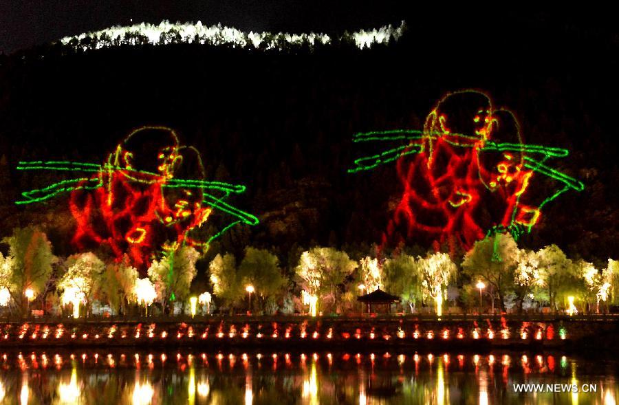 Photo taken on April 8, 2013 shows a 3D scenery by lasers in scenic area of Longmen Grottoes in Luoyang, central China's Henan Province. The night tour at Longmen Grottoes, a world cultural heritage site, has been opened to public since Monday. (Xinhua/Wang Song)