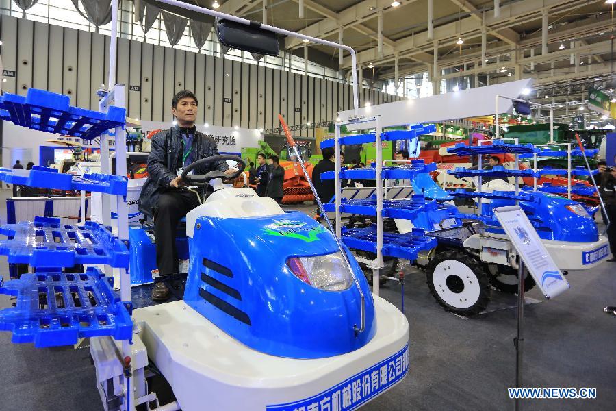 A man has a test drive of a machine at the 7th China Jiangsu International Agricultural Machinery Fair in Nanjing, capital of east China's Jiangsu Province, April 9, 2013. The three-day fair kicked off on Tuesday at Nanjing International Expo Centre. (Xinhua/Han Hua)