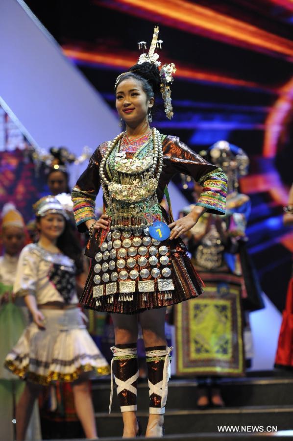 A competitor shows the costume of Dong ethnic group during the final match of the 2013 Miss Tourism International (Guizhou) in Guiyang, capital of southwest China's Guizhou Province, April 9, 2013. The final match, with the participation of 31 competitors, closed here Tuesday. (Xinhua/Ou Dongqu)