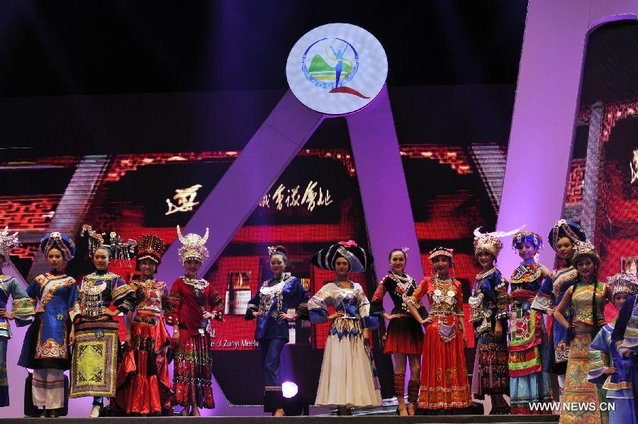 Competitors show the costumes of Chinese ethnic minorities during the final match of the 2013 Miss Tourism International (Guizhou) in Guiyang, capital of southwest China's Guizhou Province, April 9, 2013. The final match, with the participation of 31 competitors, closed here Tuesday. (Xinhua/Ou Dongqu)
