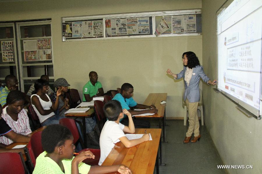 Tao Jing, a Chinese teacher from the Language Centre of University of Namibia, teaches local students Chinese in Windhoek, Namibia, April 8, 2013. To fulfill the agreement on higher-education cooperation between China and Namibia, China's universities started dispatching teachers to work at University of Namibia since mid-1990s. The Chinese teachers have since gained respect and good reputation because of their diligent work and serious attitude in academics. They have made remarkable contributions to the cultivation of local talents and the friendship between China and Namibia. (Xinhua/Gao Lei) 