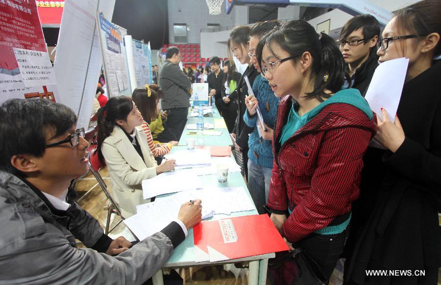 Job hunters take part in a job fair at the Tianjin University of Finance and Economics in Tianjin, north China, April 10, 2013. The job fair attracted 225 enterprises and institutions, providing 4,700 job vacancies for college graduates. (Xinhua/Liu Dongyue)  