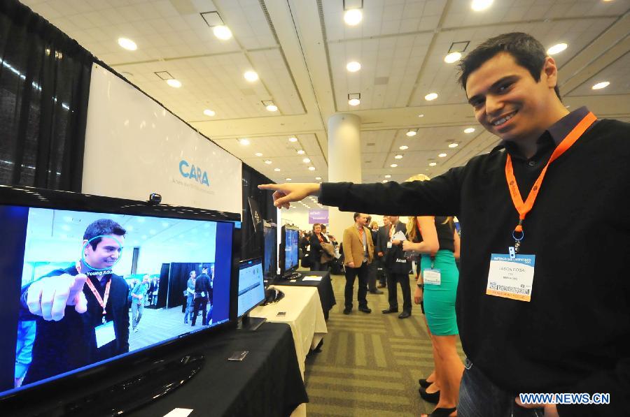 Jason Sosa, CEO of IMRSV Inc., introduces intelligent sensors in the "ad:tech San Francisco 2013" in San Francisco, the United States, April 9, 2013. The two-day exposition has over 30 lectures and about 200 booths for international advertisement companies and clients. (Xinhua/Liu Yilin) 