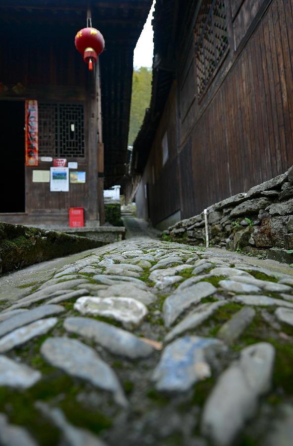 Photo taken on April 10, 2013 shows a cobbly road in Lianghekou Village in Enshi, central China's Hubei Province. Stilted buildings of Tujia ethnic group, mainly seen in central China's Hunan and Hubei Province, is a gem of Chinese residence. Lianghekou Village is one of the best reserved areas for Tujia stilted buildings. (Xinhua/Song Wen) 