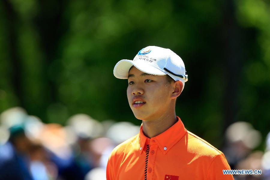 China's Guan Tianlang walks to the No. 1 green during the Par 3 Contest for the 2013 Masters at the Augusta National Golf Club in Augusta, Georgia, the United States, on April 10, 2013. (Xinhua/Chris Trotman/Augusta National)