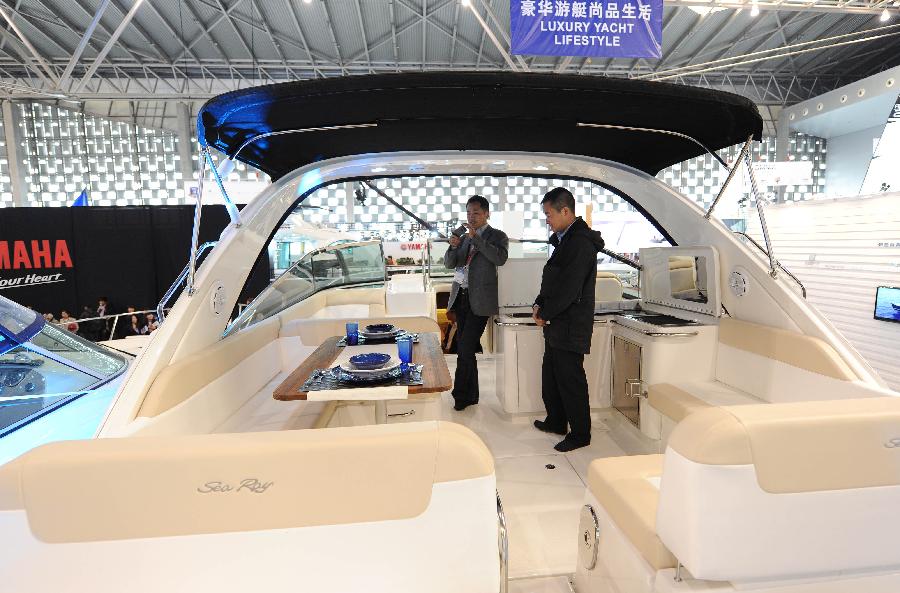 Visitors view a yacht during the 18th China (Shanghai) International Boat Show (CIBS) at the Shanghai World Expo Exhibition & Convention Center in Shanghai, east China, April 11, 2013. A total of 550 real boats from 500 exhibitors were displayed at the four-day-long CIBS that kicked off on Thursday. (Xinhua/Lai Xinlin) 
