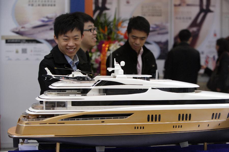 Visitors view a yacht model during the 18th China (Shanghai) International Boat Show (CIBS) at the Shanghai World Expo Exhibition & Convention Center in Shanghai, east China, April 11, 2013. A total of 550 real boats from 500 exhibitors were displayed at the four-day-long CIBS that kicked off on Thursday. (Xinhua/Jin Xin)