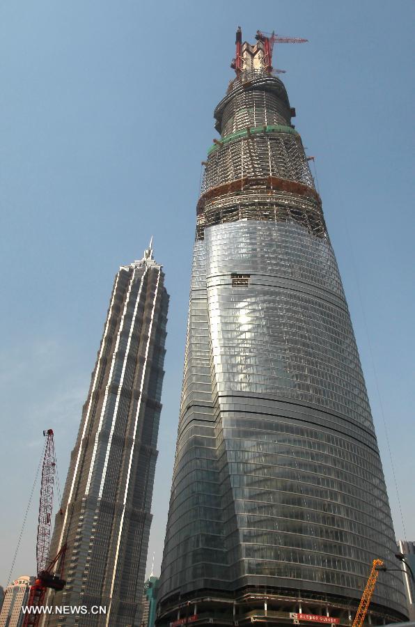 Photo taken on April 11, 2013 shows the Shanghai Tower (R) under construction in east China's Shanghai Municipality. The height of the Shanghai Tower, which is still under construction, reached 501.3 meters Thursday, surpassing the neighbouring Jinmao Tower and the World Financial Center. The designed height of the Shanghai Tower will be 632 meters, the tallest skyscraper in China. (Xinhua/Pei Xin) 