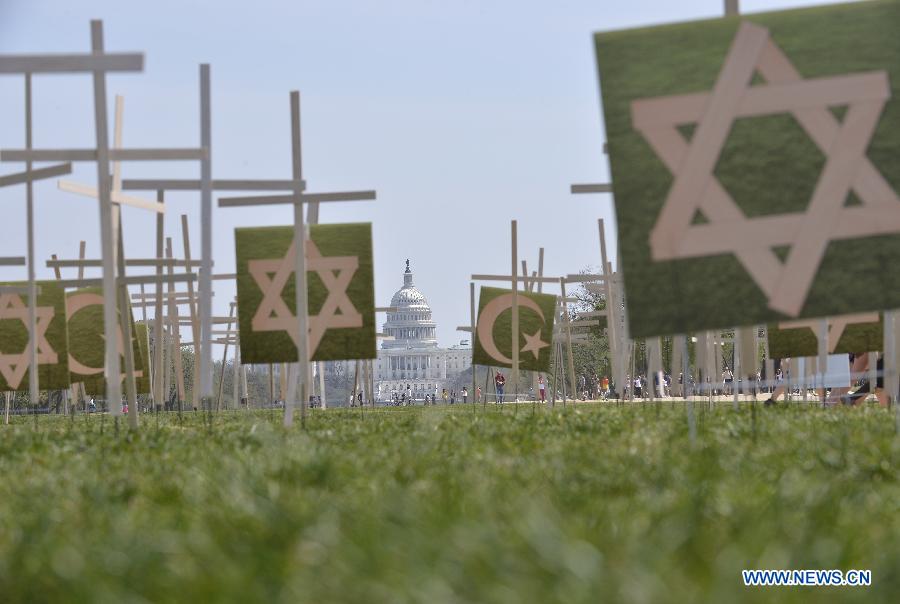 Grave markers are erected in a mock cemetery to honor the victims of gun violence during a 24-hour vigil on the National Mall in Washington D.C., capital of the United States, April 11, 2013. The U.S. Senate on Thursday voted to open debate on gun control measures advocated by President Barack Obama and mostly Democratic lawmakers, clearing the first hurdle for relevant legislation. (Xinhua/Wang Yiou) 