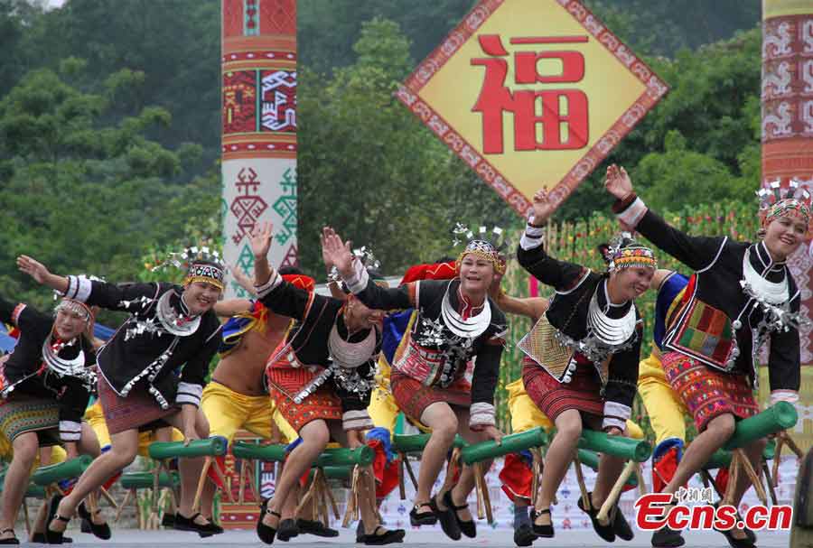 Women of the Li ethnic group perform at the Sanyuesan Festival in Qiongzhong, Hainan Province, April 11, 2013. The festival, which is celebrated on the third day of the third lunar month, provides unmarried young people an opportunity to find their loved ones. On that day the young boys and girls from nearby settlements get together in bright and attractive clothing. They hold hands and sing songs, do bamboo pole dancing, and have their dates in houses that are shaped like boats. (CNS/Fu Meibin)