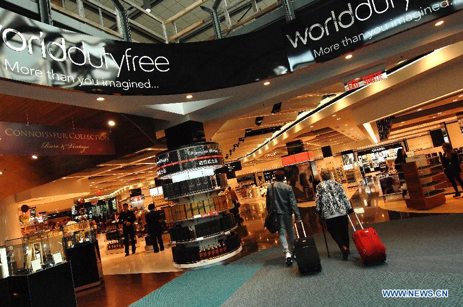 Travellers walk at a World Duty Free store at Vancouver International Airport (YVR) in Vancouver, Canada, April 10, 2013. YVR was named Best Airport in North America at the Skytrax World Airport Awards in Geneva, Switzerland on April 10. YVR is rated 8th overall worldwide and is the only North American airport included in the top ten. (Xinhua/Sergei Bachlakov) 