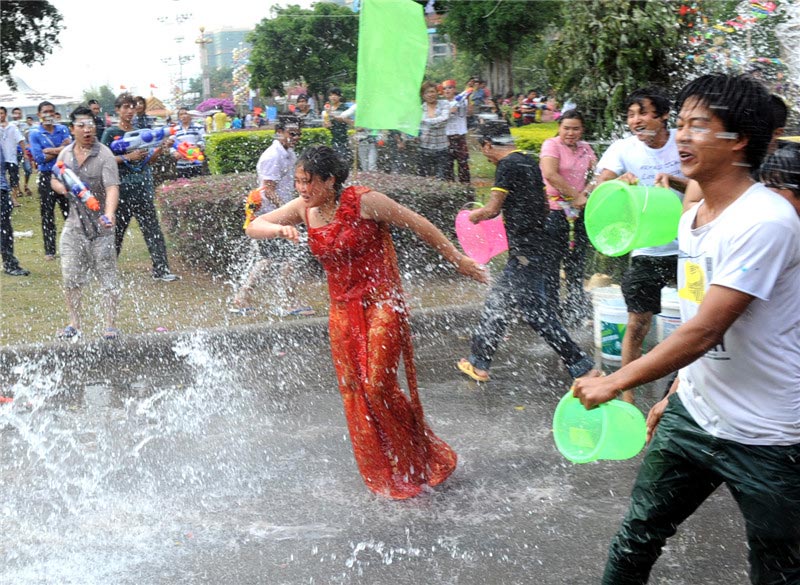 A woman is drenched in the Water Splashing Festival celebrations in Dehong Dai and Jingpo autonomous prefecture in Yunnan on April 11, 2013. (Xinhua)