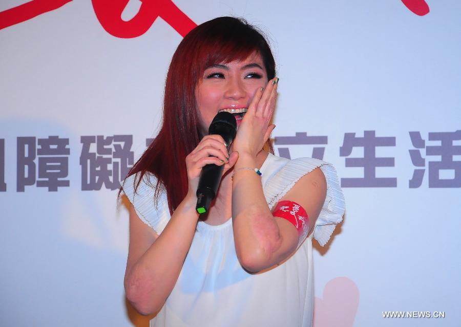 Singer Selina from pop group S.H.E receives interview at a press conference of a commonweal fundraising activity for the disabilities in Taipei, southeast China's Taiwan, April 11, 2013. (Xinhua) 