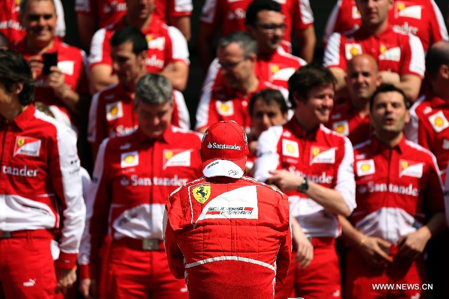 Team members of Ferrari pose for a group photo before the first practice session of the Chinese F1 Grand Prix at the Shanghai International circuit, in Shanghai, east China, on April 12, 2013. (Xinhua/Li Ming)