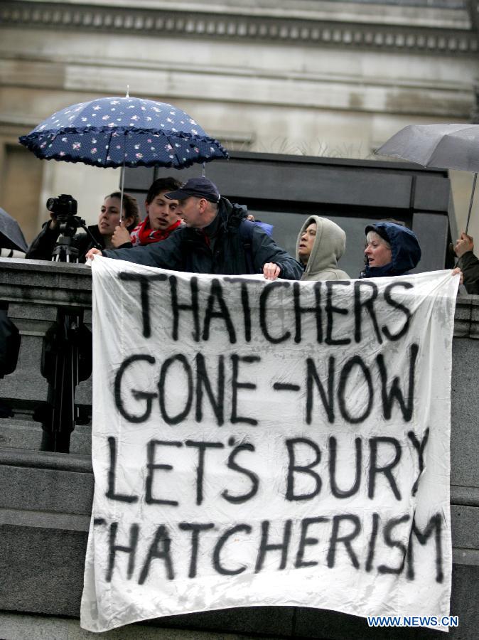 Protesters hold a banner during a party marking former British Prime Minister Margaret Thatcher's death in central London's Trafalgar square, on April 13, 2013. Parties staged by opponents of Margaret Thatcher to celebrate her death took place in several locations across the UK on Saturday. (Xinhua/Bimal Gautam) 