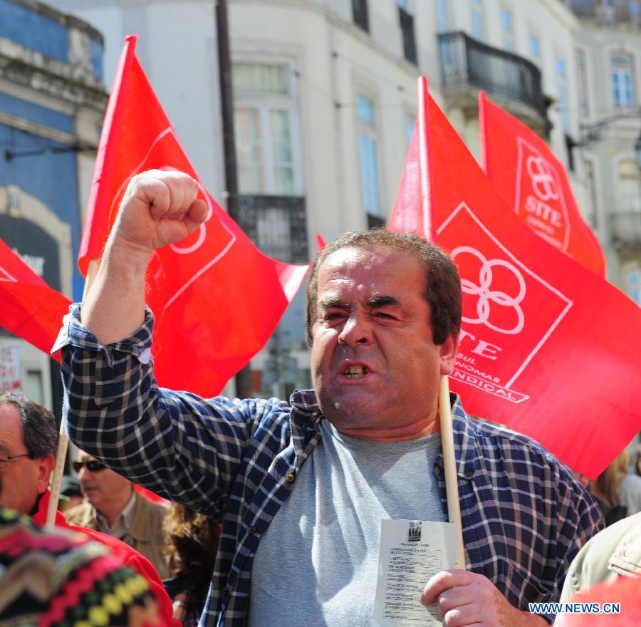A Portuguese shouts slogans during a protest in Lisbon, Portugal, April 13, 2013. Some 1,000 Portuguese took to the streets in Lisbon on Saturday in protest against the government's tough austerity measures that were widely blamed for deepening economic recession in the heavily debted country. (Xinhua/Zhang Liyun) 
