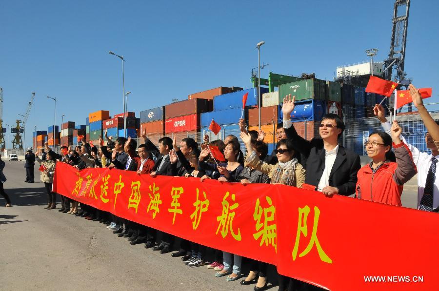 Local Chinese wave goodbye to Chinese navy soldiers in Casablanca, Moroco, April 13, 2013. The 13th Escort Taskforce of the Chinese navy on Saturday ended a five-day visit to Morocco. (Xinhua/Lin Feng)