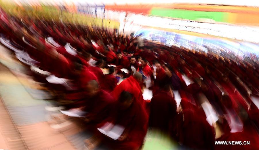 Buddhists chant sutras for the earthquake victims during a Buddhist commemoration marking the third anniversary of the Yushu earthquake, in Yushu Tibetan Autonomous Prefecture, northwest China's Qinghai Province, April 14, 2013. A 7.1-magnitude earthquake hit Yushu on April 14, 2010, leaving 2,698 dead and over 12,000 injured. (Xinhua/Zhang Hongxiang)