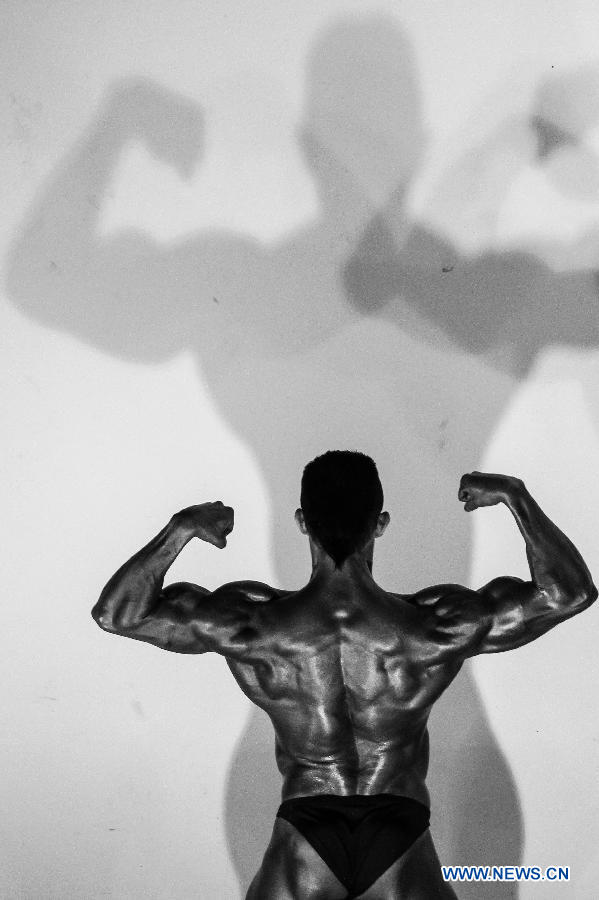 A bodybuilder participates in a bodybuilding competition called "Mr. Colombia" held in Bogota, capital of Colombia, on April 13, 2013. (Xinhua/Jhon Paz)