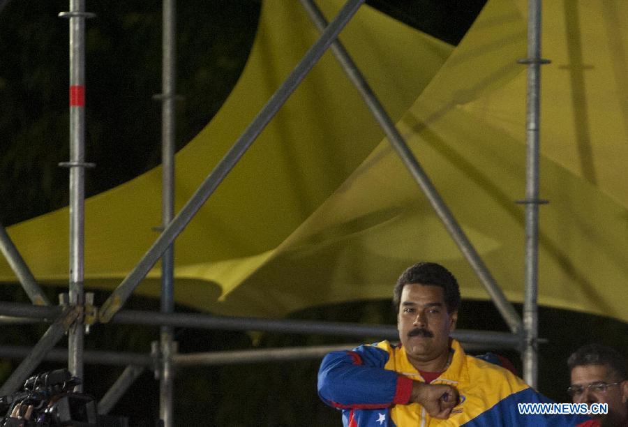 Venezuelan acting President Nicolas Maduro celebrates his victory in Caracas, capital of Venezuela, on April 14, 2013. Venezuelan Acting President Nicolas Maduro narrowly won the presidential election with 50.66 percent of the votes, National Electoral Council's President Tibisay Lucena said on Sunday. (Xinhua/Mauricio Valenzuela) 