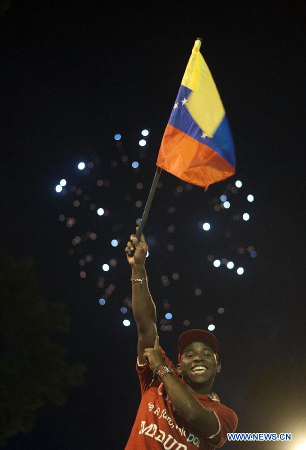 Supporters of Venezuelan acting President Nicolas Maduro celebrate his victory in Caracas, capital of Venezuela, on April 14, 2013. Venezuelan acting President Nicolas Maduro narrowly won the presidential election with 50.66 percent of the votes, National Electoral Council's President Tibisay Lucena said on Sunday. (Xinhua/Mauricio Valenzuela)