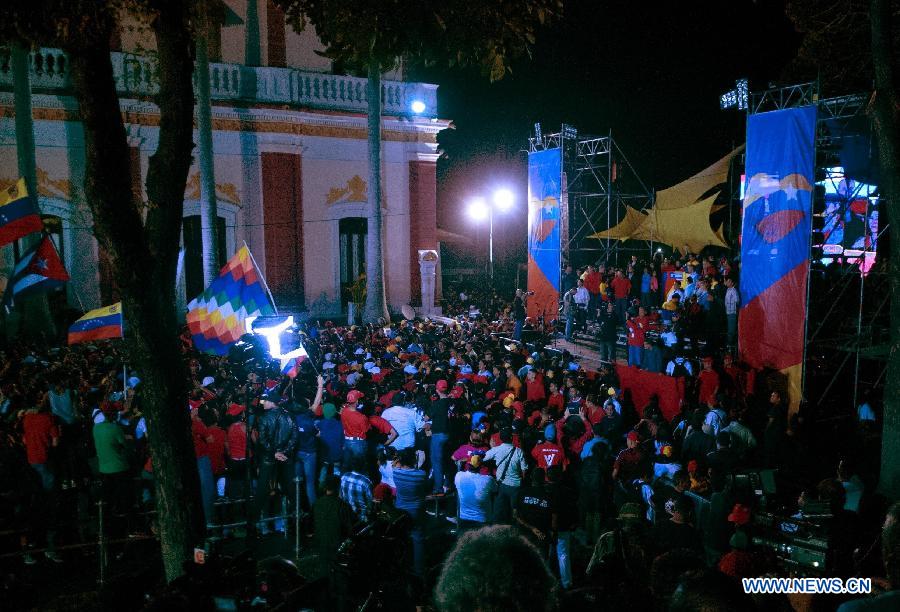 Supporters of Venezuelan acting President Nicolas Maduro celebrate his victory in Caracas, capital of Venezuela, on April 14, 2013. Venezuelan acting President Nicolas Maduro narrowly won the presidential election with 50.66 percent of the votes, National Electoral Council's President Tibisay Lucena said on Sunday. (Xinhua/Mauricio Valenzuela)