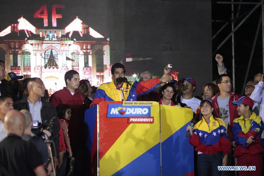 Venezuelan acting President Nicolas Maduro (C) celebrates his victory in Caracas, capital of Venezuela, on April 14, 2013. Venezuelan acting President Nicolas Maduro narrowly won the presidential election with 50.66 percent of the votes, National Electoral Council's President Tibisay Lucena said on Sunday. (Xinhua/AVN)