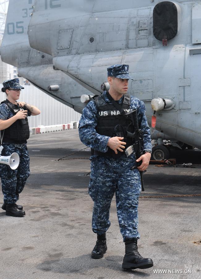 A U.S. navy serviceman patrols on the USS Peleliu, the flagship of the Amphibious Squadron Three, in Hong Kong, south China, April 15, 2013. Three ships of the U.S. navy Amphibious Squadron Three started to make a port visit in Hong Kong on Monday to get replenishment. USS Peleliu pulled into the Ocean Terminal besides Tsim Sha Tsui, on the northern bank of the landmark Victoria Harbor in the morning. The other two ships anchored in waters outside the Harbor. (Xinhua/Wong Pun Keung) 