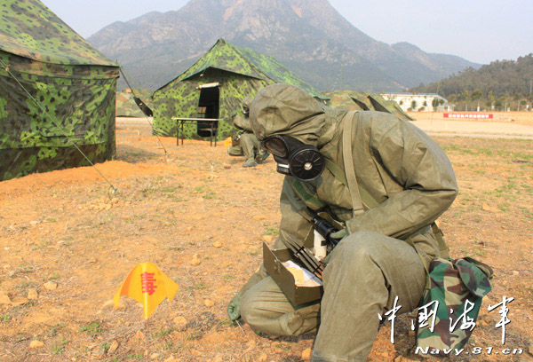 A shore-based mobile anti-ship-missile regiment under the South China Sea Fleet of the Navy of the Chinese People's Liberation Army (PLA) organized a NBC (nuclear, biological and chemical) defense drill against actual-combat background on April 7, 2013. The picture shows the officers and men of the regiment are carrying out decontamination and detection of chemical agents in the infected "toxic" areas. (China Military Online/Sheng Yuehua, Zhao Changhong and Zheng Can)