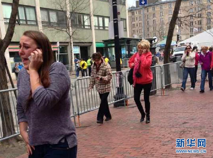 People react following explosions happened in Boston, the United States, April 15, 2013. Three explosions occurred near the Boston Marathon finish line, killing at least 2 people, local media reported. (Xinhua/Zhao Xirong) 