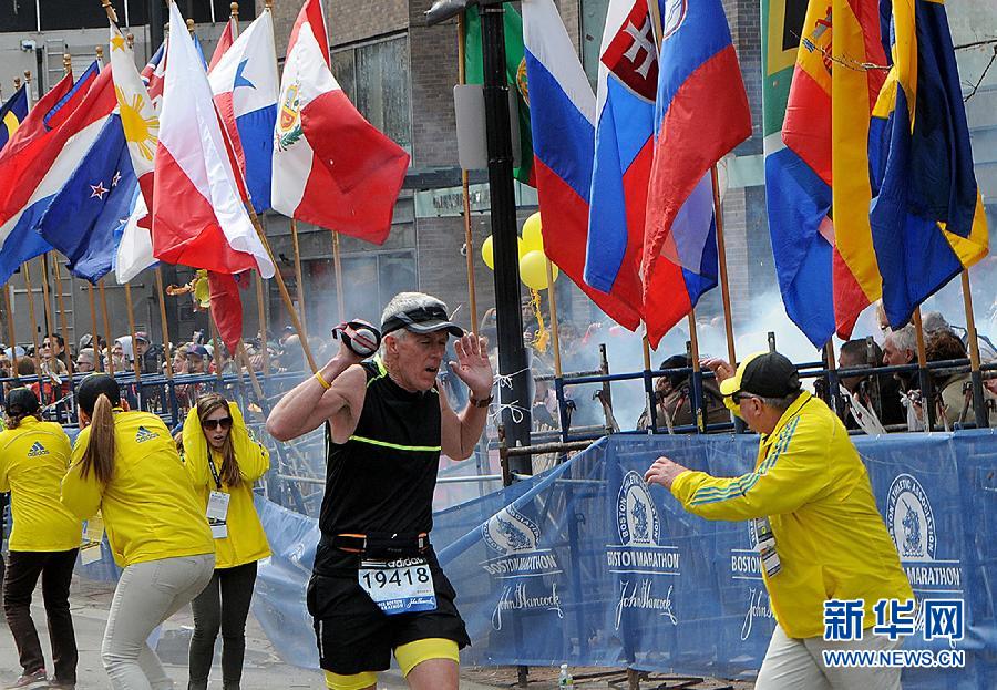 People react following explosions happened in Boston, the United States, April 15, 2013. Three explosions occurred near the Boston Marathon finish line, killing at least 2 people, local media reported. (Xinhua/Zhao Xirong) 