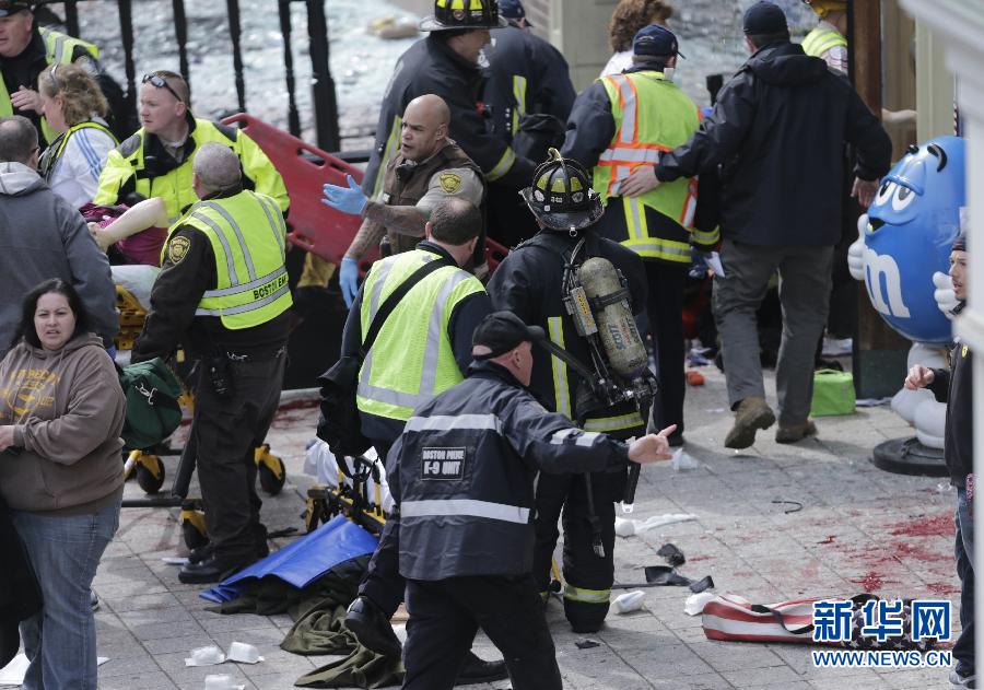 People react following explosions happened in Boston, the United States, April 15, 2013. Three explosions occurred near the Boston Marathon finish line, killing at least 2 people, local media reported. (Xinhua/Zhao Xirong) 