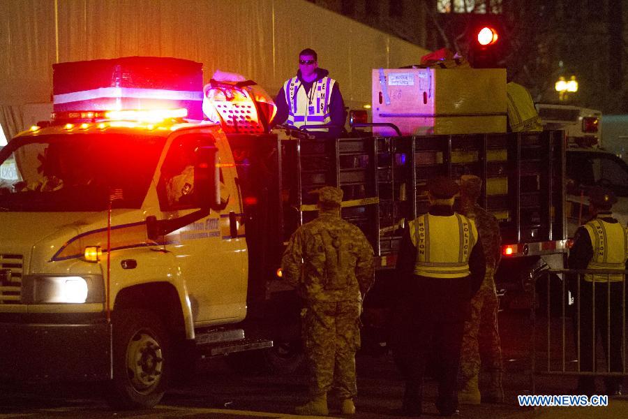 Boston EMS carries materials in front of the scene of the explosion in Boston, the United States, April 15, 2013. The two explosions that rocked the Boston Marathon on Monday has killed three people and injured at least 138, officials and media outlets said. (Xinhua/Marcus DiPaola)