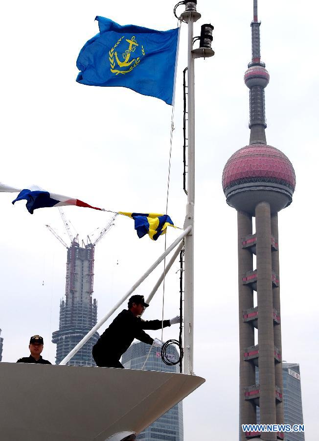 A crew member raises the flag at the delivery ceremony of patrol vessel Haixun 01 at a port in Shanghai, east China, April 16, 2013. Haixun 01, officially delivered and put into service Tuesday and managed by the Shanghai Maritime Bureau, is China's largest and most advanced patrol vessel. The 5,418-tonnage Haixun01 is 128.6 meters in length and has a maximum sailing distance of 10,000 nautical miles (18,520 km) without refueling. It will carry out missions regarding maritime inspection, safety monitoring, rescue and oil spill detection and handling. (Xinhua/Chen Fei) 