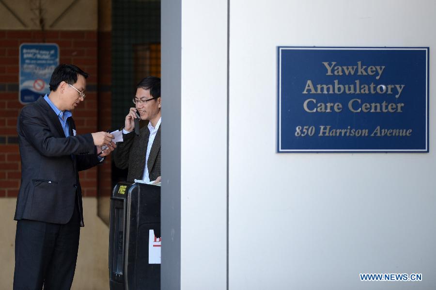 Chinese Vice Counselor-General Zhong Ruiming (R) and counselor Zhou Maoyi of the Chinese Consulate General in New York discuss with each other about the injured Chinese student and other casualties at the Boston Medical Center in Boston, the United States, April 16, 2013. Chinese student Zhou Danling, who was injured during the Boston marathon blasts, turned into better condition from critical one after receiving two surgeries. (Xinhua/Wang Lei) 