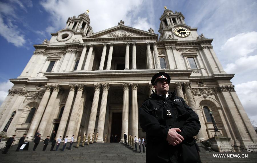 A police officer stands outside St Paul's Cathedral ahead of the funeral of former Prime Minister Margaret Thatcher in London, April 16, 2013. A ceremonial funeral service for Lady Thatcher will be held at St Paul's Cathedral in London on Wednesday. (Xinhua/Wang Lili) 