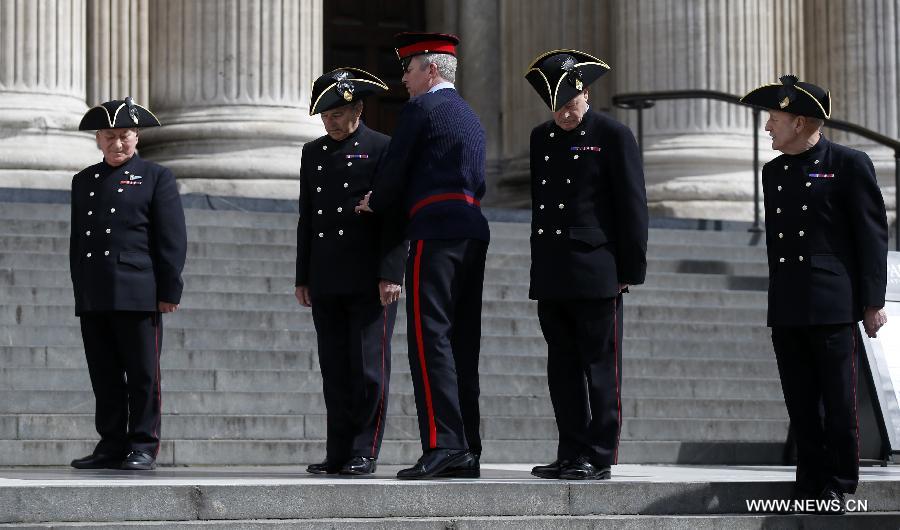 People to attend the funeral of former Prime Minister Margaret Thatcher rehearse outside St Paul's Cathedral in London, April 16, 2013. A ceremonial funeral service for Lady Thatcher will be held at St Paul's Cathedral in London on Wednesday. (Xinhua/Wang Lili) 