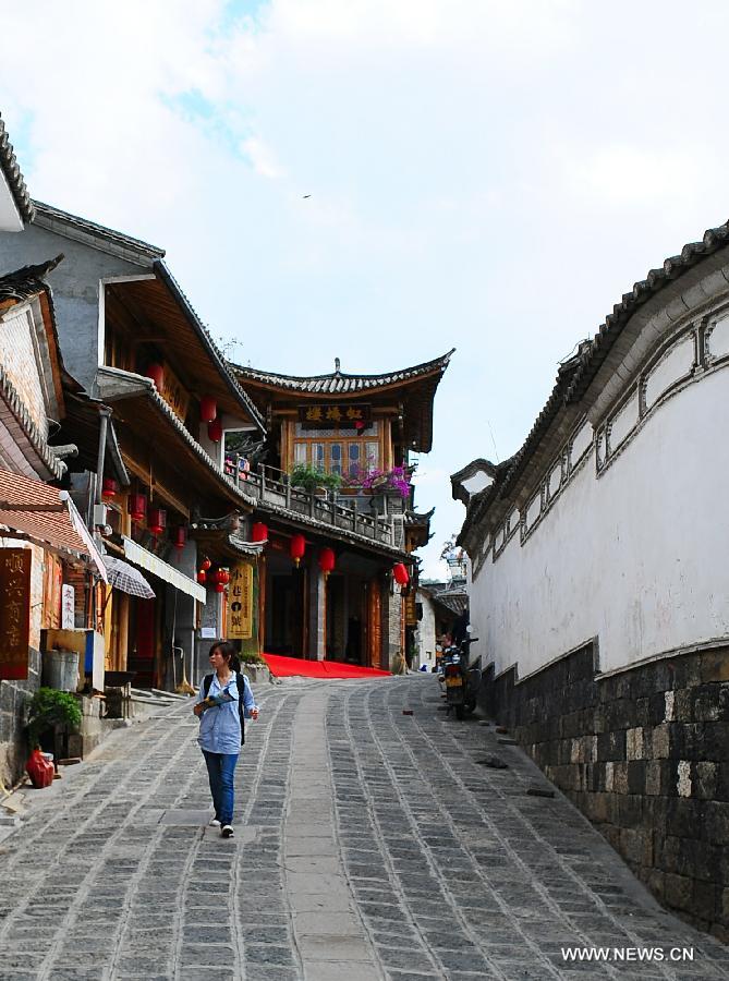 A woman visits the ancient townlet Heshun in Tengchong County, southwest China's Yunnan Province, April 16, 2013. The townlet, featuring time-honored temples and houses, is located three kilometers away from the county seat of Tengchong, where live 6,000 people. (Xinhua/Qin Lang)