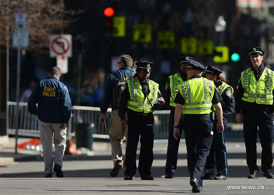 Policemen work at the blast site in Boston, the United States, April 17, 2013. U.S. investigators believed that they have identified a suspect for Monday's Boston Marathon bombings, which killed three people and injured over 170 others, U.S. media reported on Wednesday. (Xinhua/Wang Lei)  